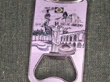 imã de geladeira de metal abridor de garrafa cinza com pontos turísticos do Rio de Janeiro, maracanã, Corcovado, Lapa, bondinho, bandeira do Brasil